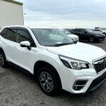 2020 subaru forester sk9 in white shown from the front three quarter angle.