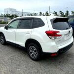 2020 subaru forester sk9 in white shown from the rear three quarter angle.